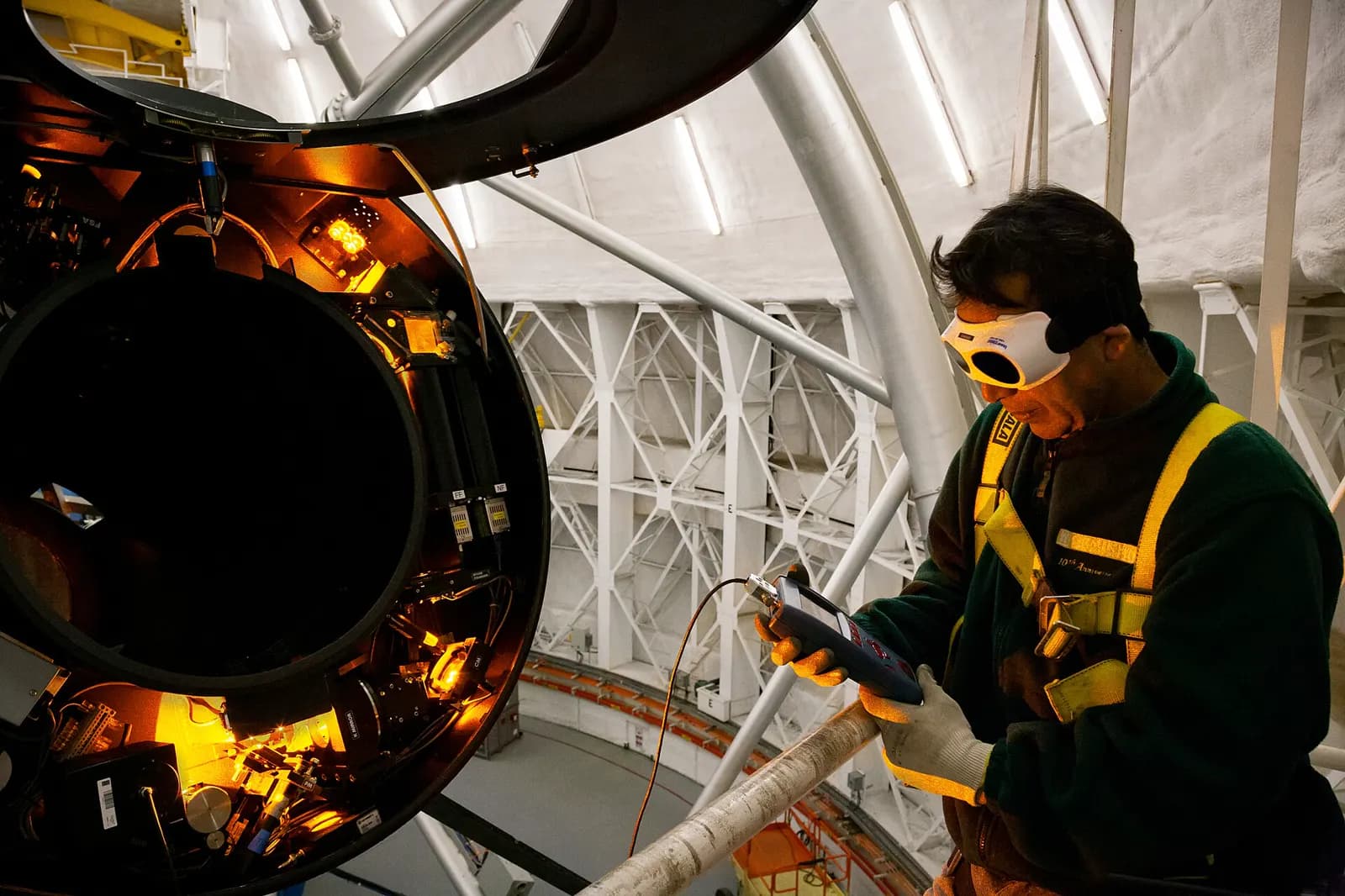 An engineer aligning a laser on an optical bench