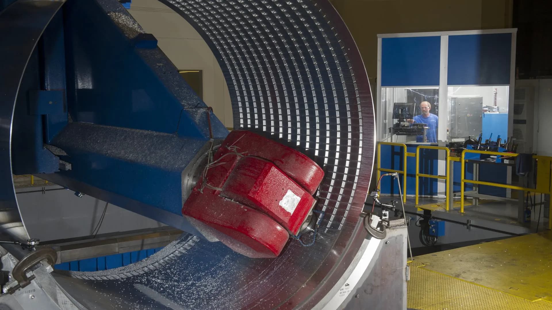 A machining head working inside a large ribbed barrel