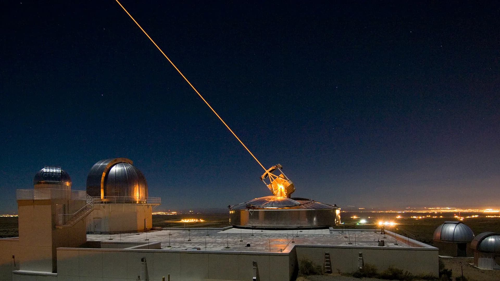 An optical range telescope projecting a laser beacon into the night sky