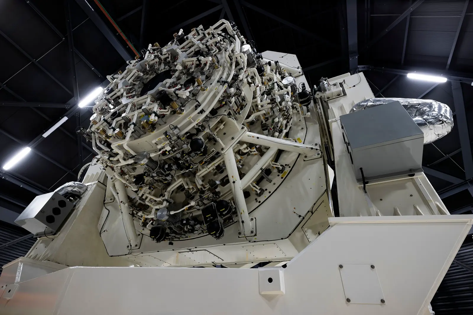 A large space surveillance telescope assembly standing in a hangar